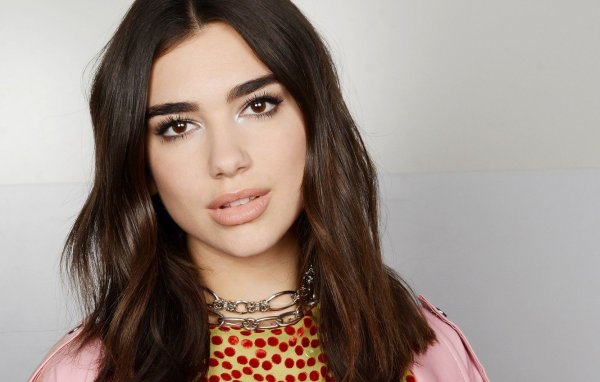Dua Lipa in a Barbie outfit is relaxing by the sea