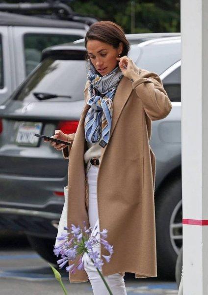 "Everything is bad": Meghan Markle hit the camera lenses in a warm coat and with an anti-stress patch on her arm